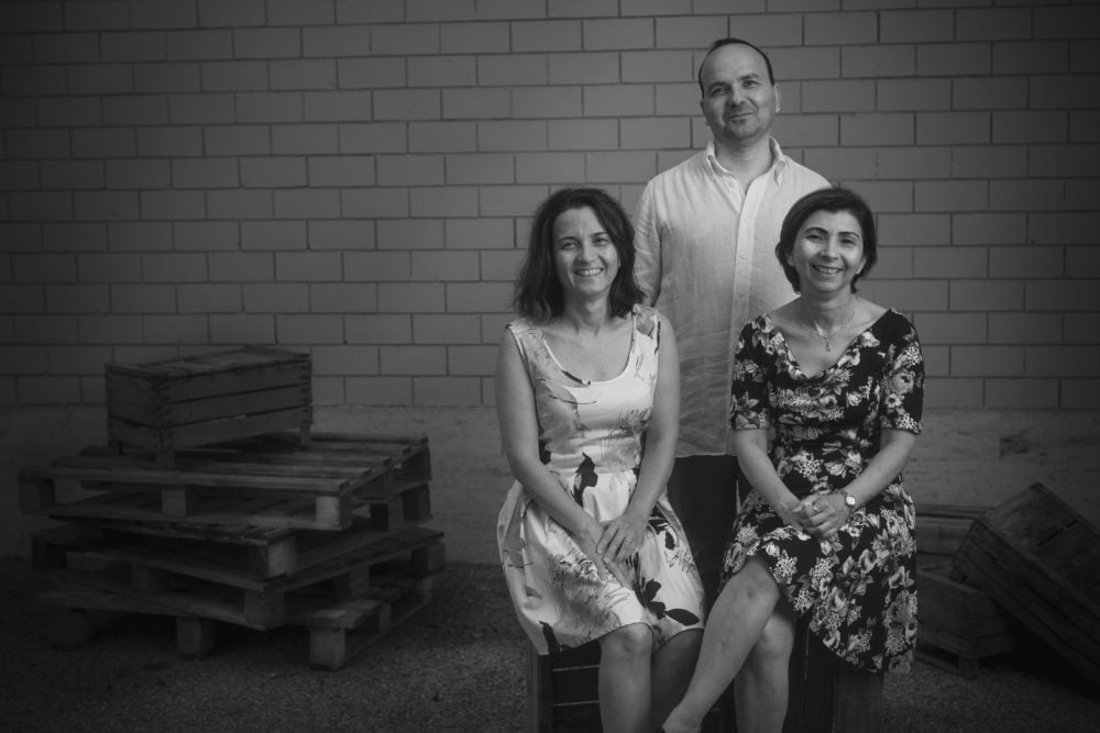 mentor artisan teaching leather skills in factory