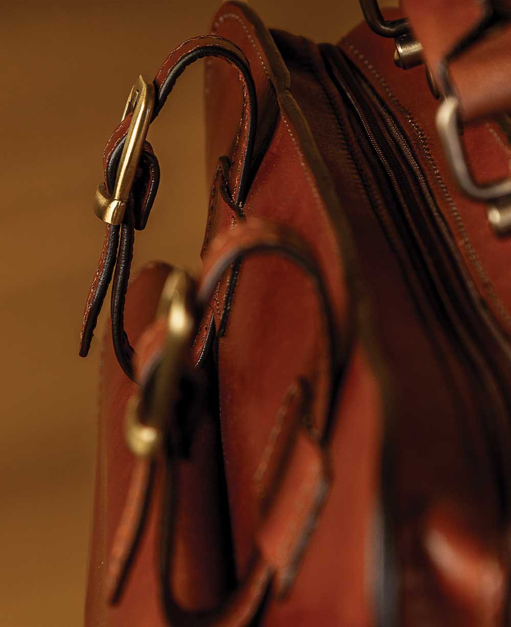 Structured leather briefcase buckle detail reflecting handcrafted leather briefcase Italy