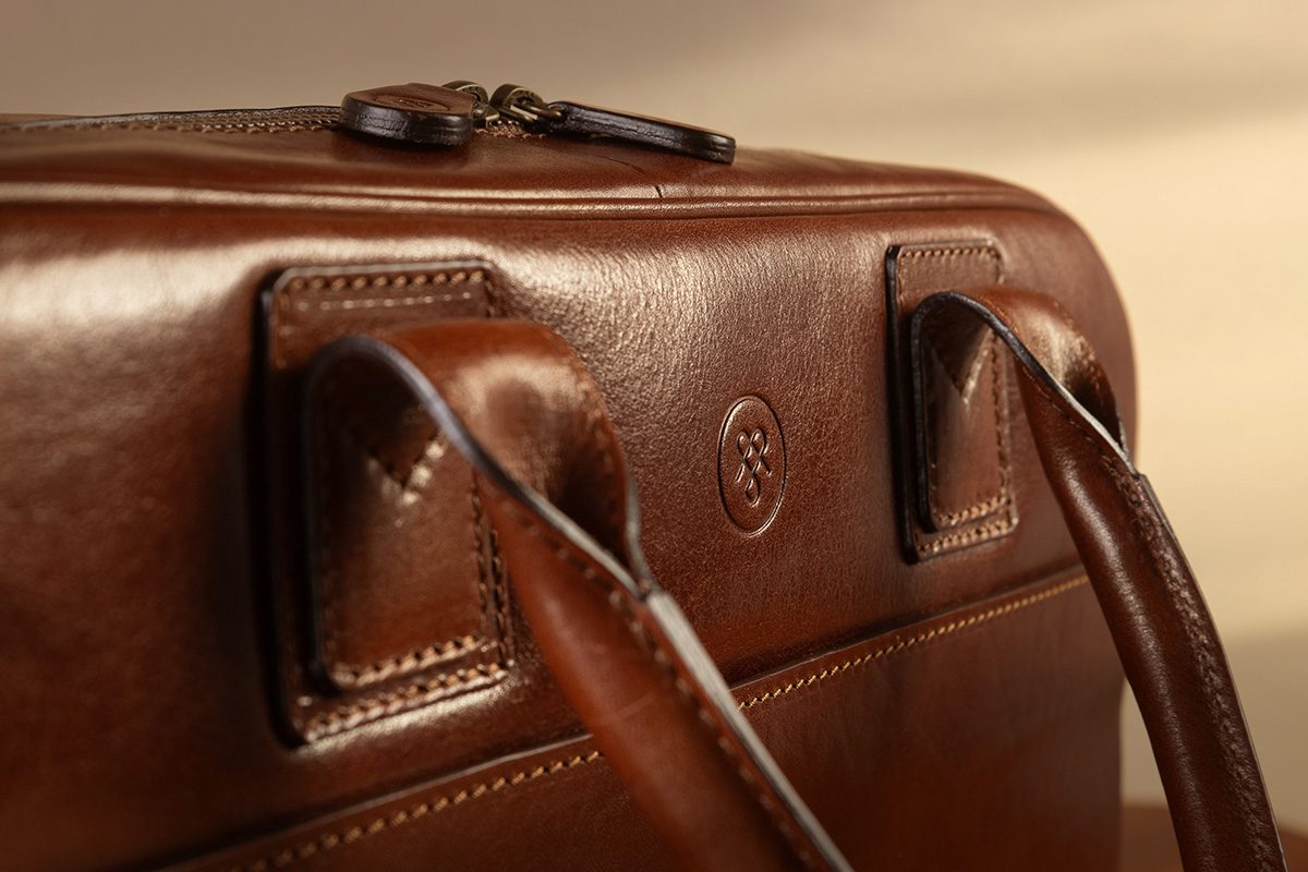 Leather craftsmanship in Italian atelier crafting full-grain leather bag